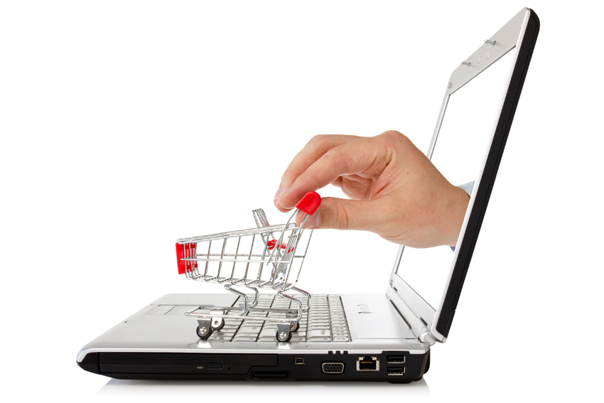 laptop and hand with shopping cart